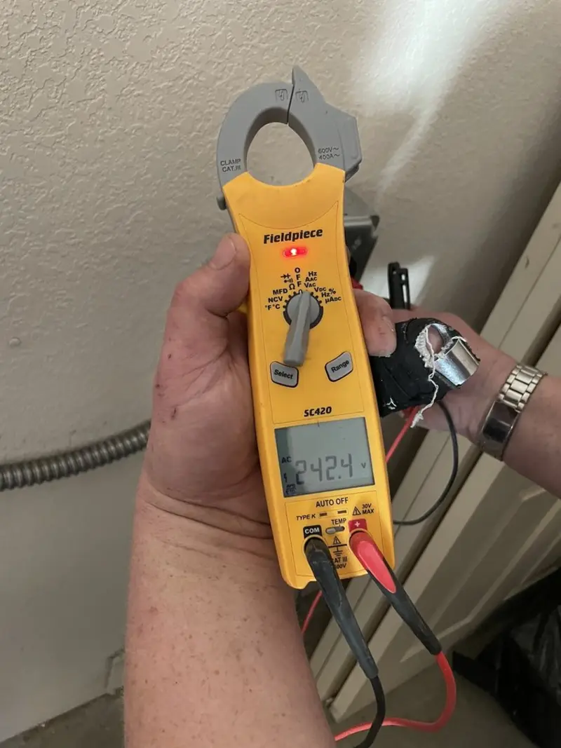Voltage testing with clamp meter during Outlet Installation in Lewisville